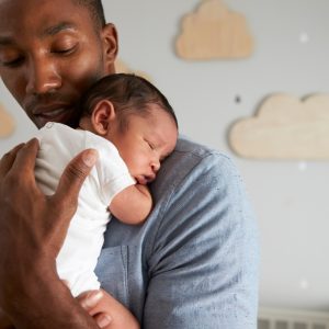 father holding baby sleeping
